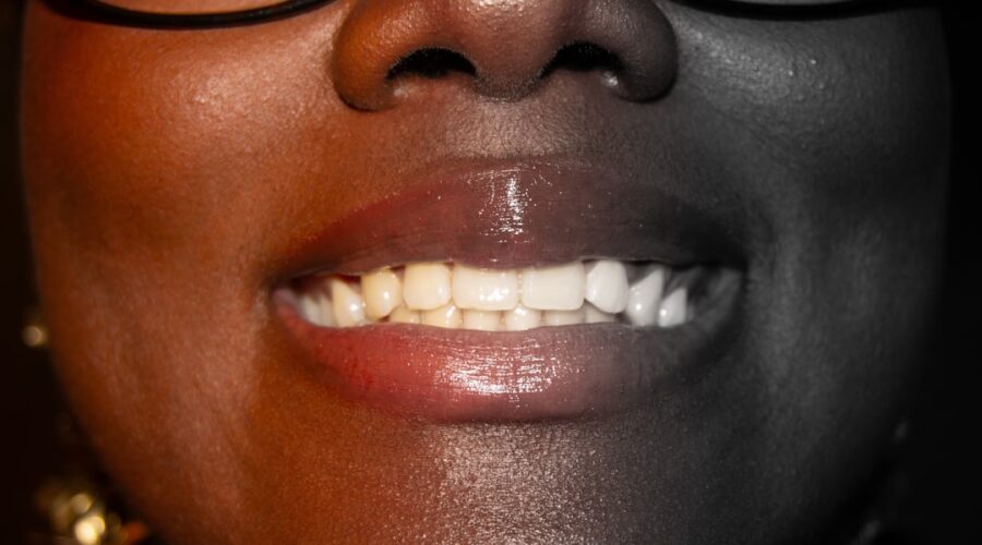 Natural Teeth Whitening Tips with a bright smile, toothbrush, whitening strips, and a clean bathroom counter