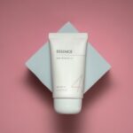Minimalist flat-lay of cleanser, serum, cream, and sunscreen symbolizing a skin barrier care routine