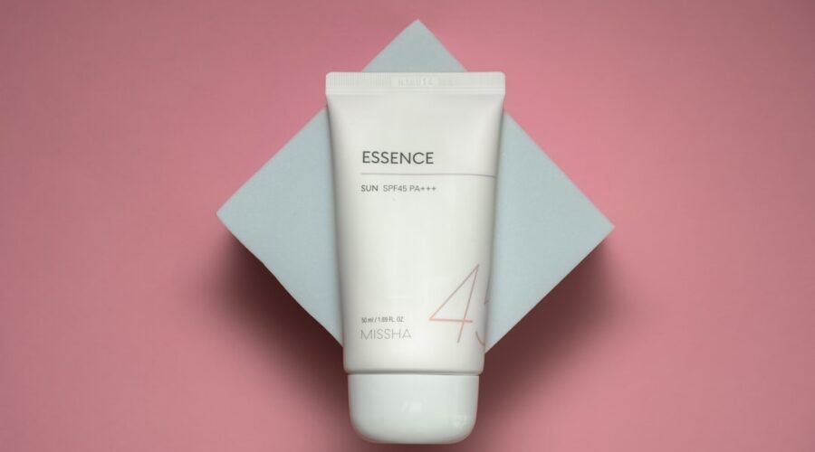 Minimalist flat-lay of cleanser, serum, cream, and sunscreen symbolizing a skin barrier care routine