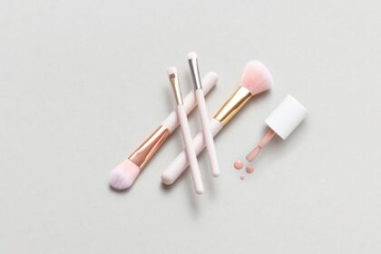 minimalist makeup routine flat lay with neutral-toned essentials