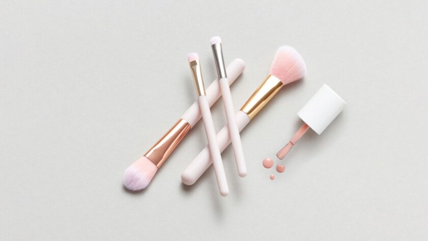 minimalist makeup routine flat lay with neutral-toned essentials