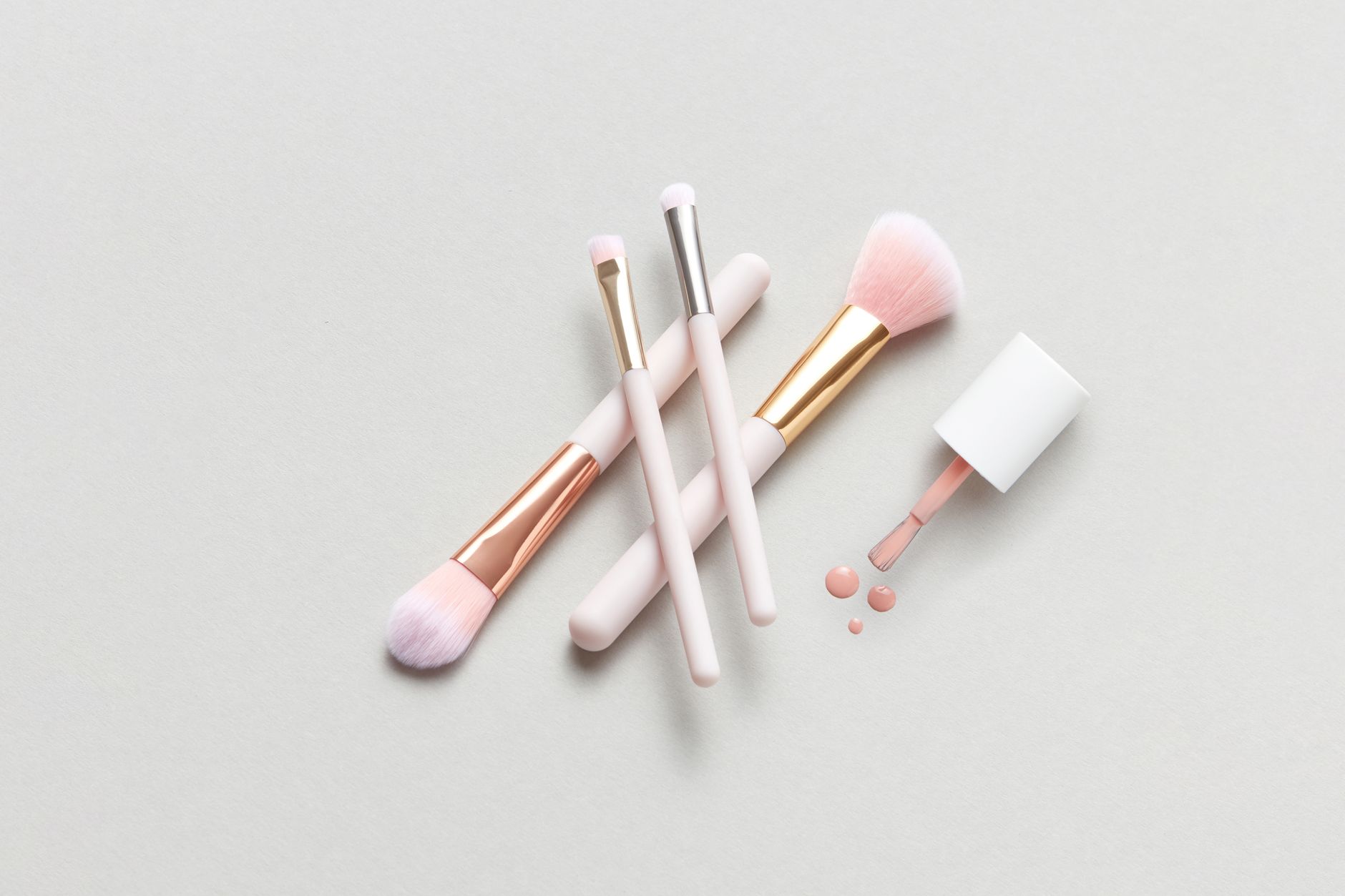 minimalist makeup routine flat lay of neutral-toned essentials
